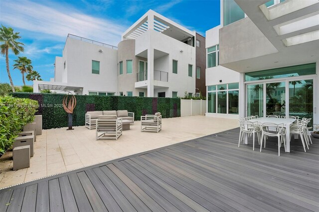 wooden deck featuring a patio and an outdoor hangout area