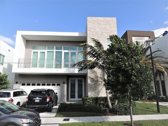 view of front of home with a garage and a balcony