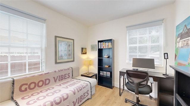 kitchen with white cabinets, stainless steel fridge with ice dispenser, plenty of natural light, and sink