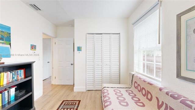 bedroom with hardwood / wood-style floors, multiple windows, and ceiling fan