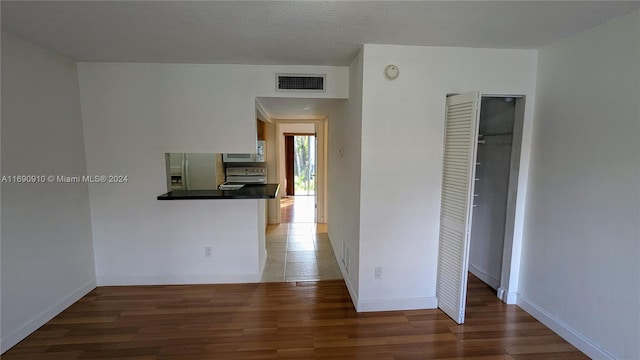 hallway with dark hardwood / wood-style flooring