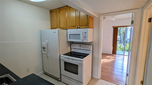 kitchen with ceiling fan, light tile patterned flooring, and white appliances