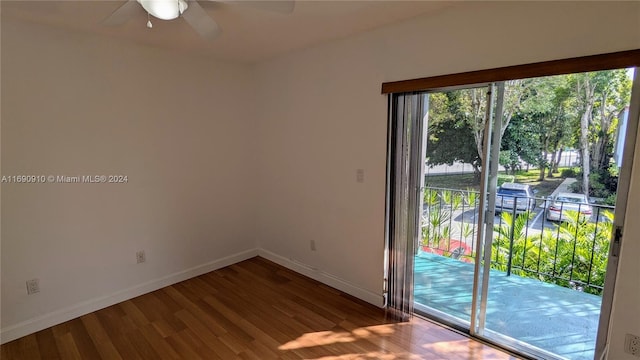 empty room with ceiling fan and hardwood / wood-style flooring