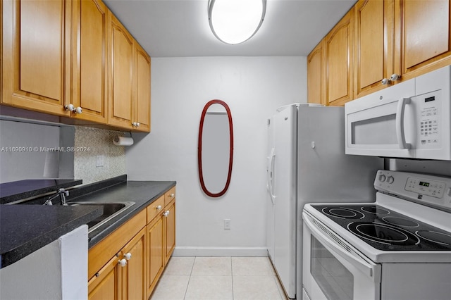 kitchen with decorative backsplash, white appliances, sink, and light tile patterned floors