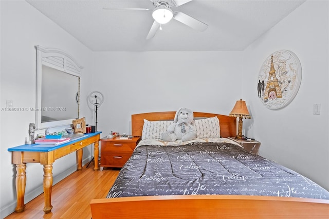 bedroom with ceiling fan and wood-type flooring