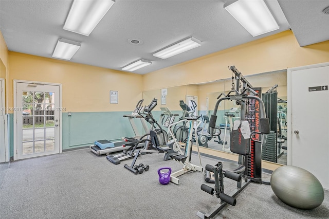 workout area with a textured ceiling