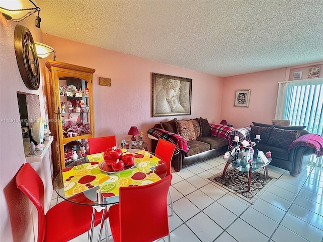 living area with a textured ceiling and tile patterned flooring