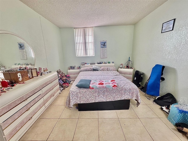 bedroom with light tile patterned flooring, a textured wall, and a textured ceiling