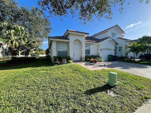 mediterranean / spanish-style house featuring a garage and a front yard