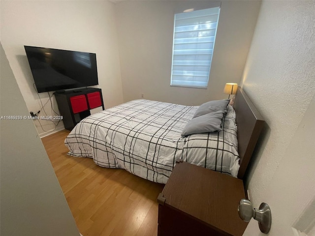 bedroom with hardwood / wood-style flooring