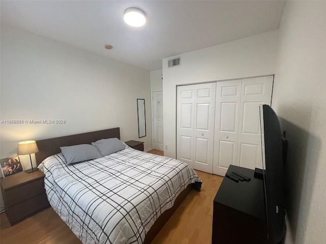 bedroom featuring hardwood / wood-style floors and a closet