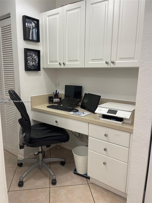 tiled office space featuring built in desk