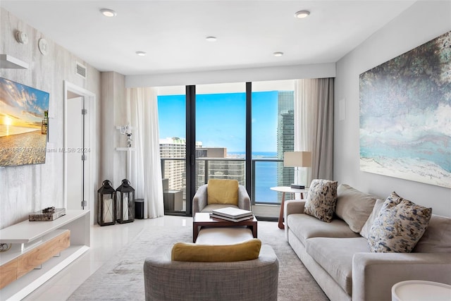 living room with light tile patterned flooring and a water view