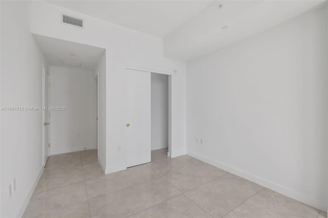 unfurnished bedroom with a closet and light tile patterned floors