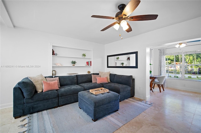 living room featuring built in shelves and ceiling fan