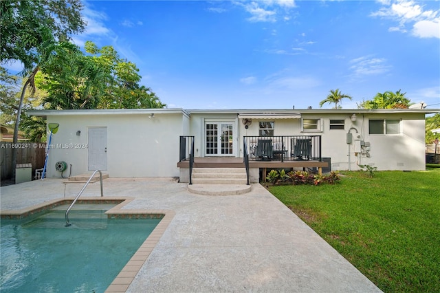 rear view of property with french doors, a yard, a fenced in pool, and a patio area