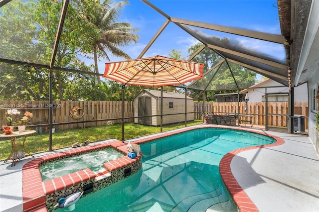 view of swimming pool featuring a shed, a lanai, an in ground hot tub, and a patio area