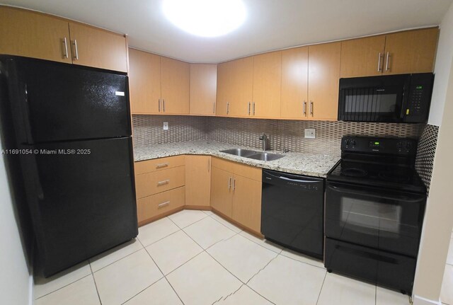 kitchen with black appliances, sink, light stone countertops, tasteful backsplash, and light tile patterned flooring