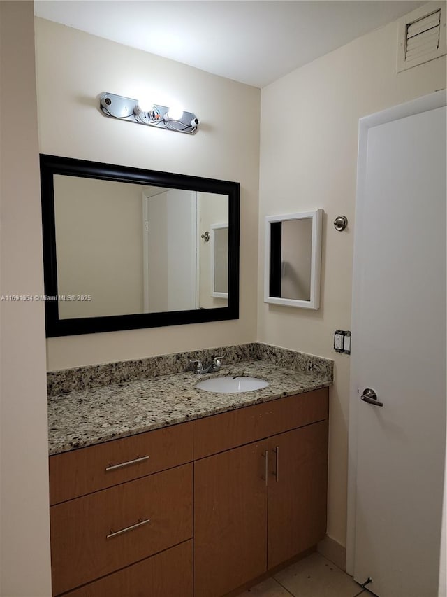 bathroom with vanity and tile patterned flooring