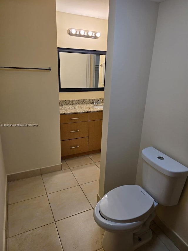 bathroom featuring tile patterned floors, toilet, and vanity