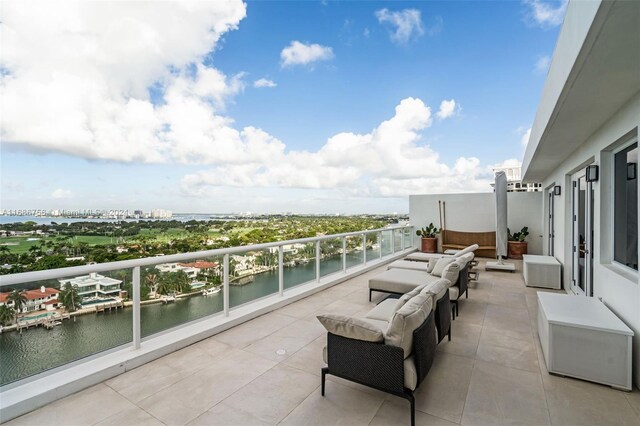 balcony with a water view and an outdoor hangout area