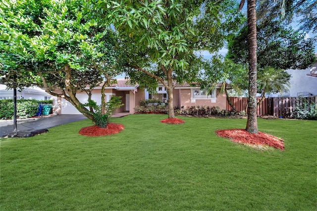 view of front of property with a garage and a front yard