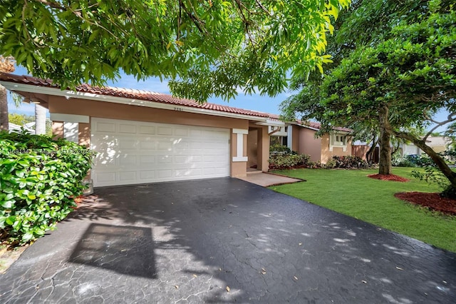 view of front of house with a garage and a front yard