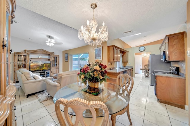 dining area with a textured ceiling, lofted ceiling, sink, a chandelier, and light tile patterned floors