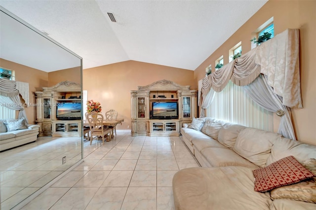 living room featuring lofted ceiling and light tile patterned flooring