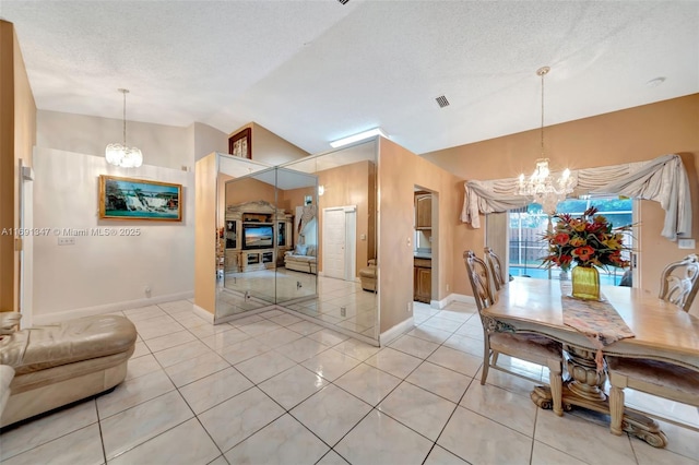 unfurnished dining area with light tile patterned flooring, a chandelier, a textured ceiling, and lofted ceiling