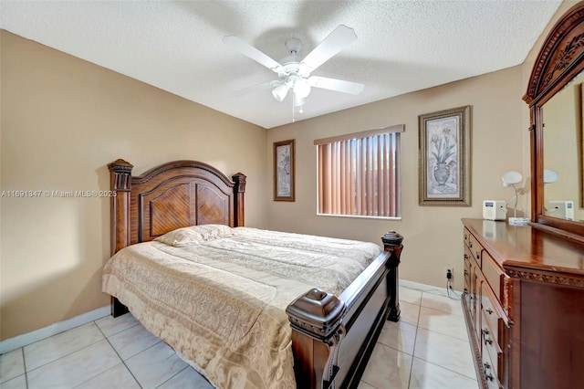 tiled bedroom featuring a textured ceiling and ceiling fan