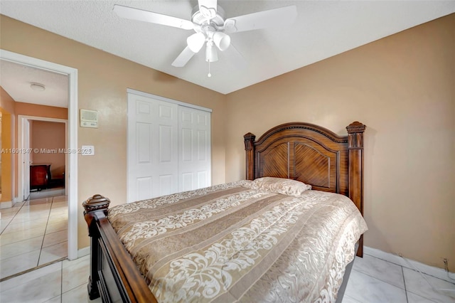 tiled bedroom with a closet and ceiling fan