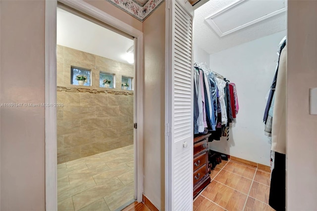 bathroom with tile patterned floors and a textured ceiling