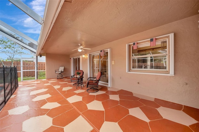 view of patio / terrace featuring ceiling fan and a lanai