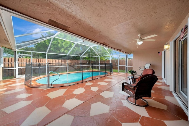 view of swimming pool with glass enclosure and a patio