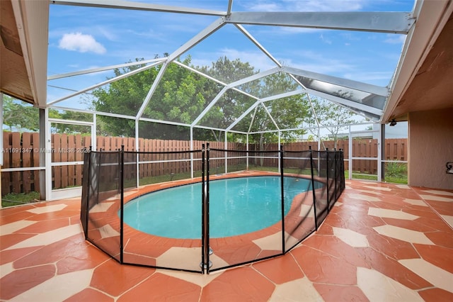 view of swimming pool with a lanai and a patio area