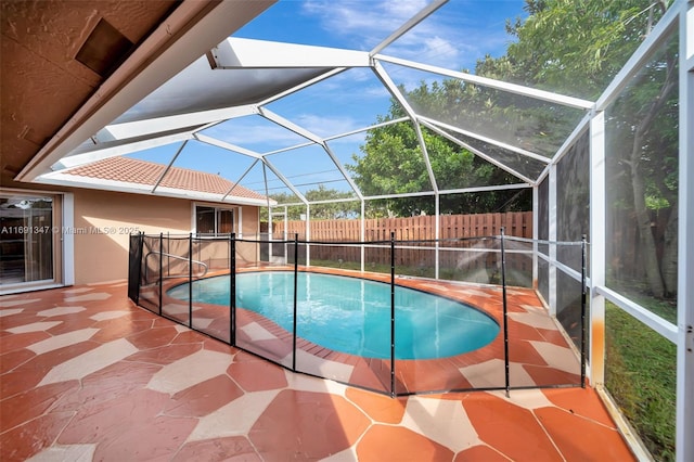 view of swimming pool featuring a lanai and a patio