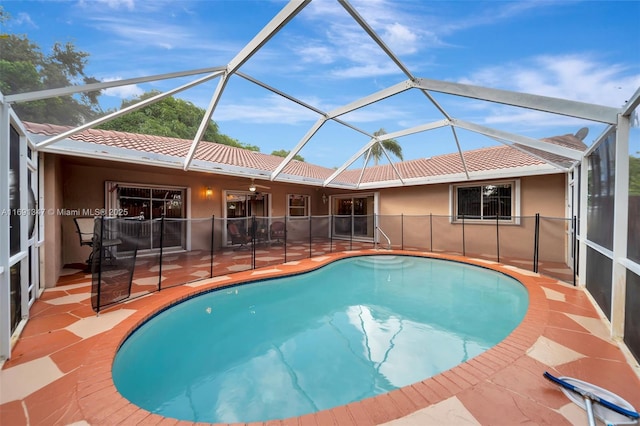 view of swimming pool with a patio area and a lanai