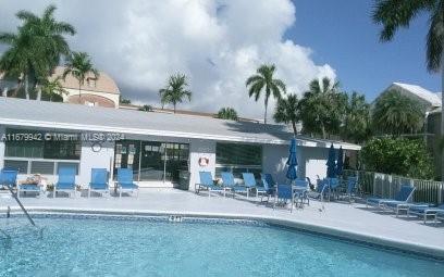 exterior space with a community pool and a patio area