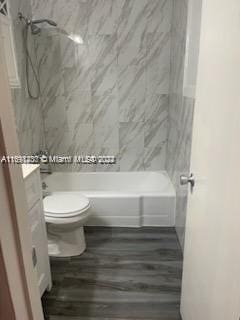 full bathroom with hardwood / wood-style flooring, vanity, toilet, and shower / bathtub combination