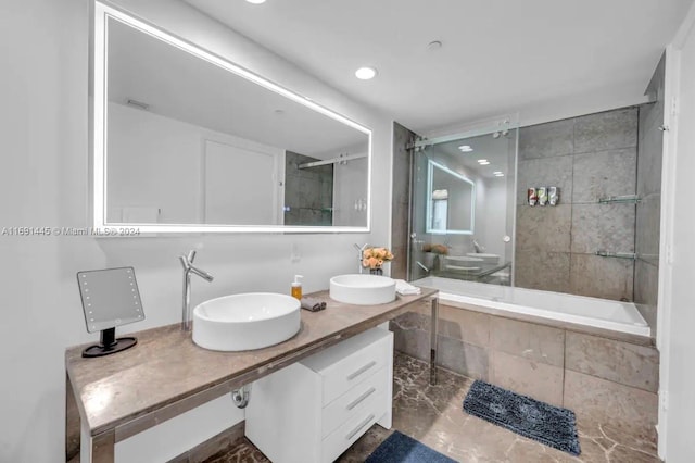 bathroom featuring enclosed tub / shower combo and vanity