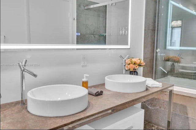 bathroom with vanity and tiled shower