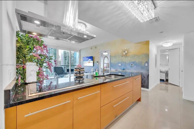 kitchen featuring black electric cooktop, sink, light tile patterned floors, and exhaust hood