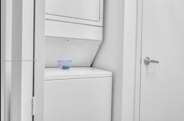 laundry room featuring stacked washer and dryer