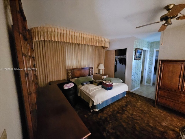 carpeted bedroom featuring a closet and ceiling fan