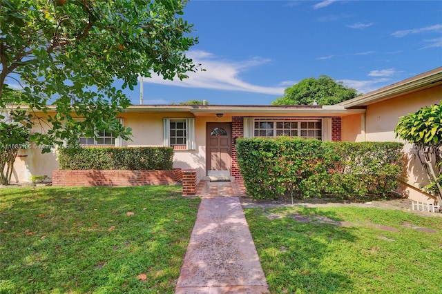 ranch-style home with a front lawn