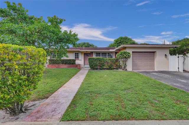 single story home featuring a front lawn and a garage