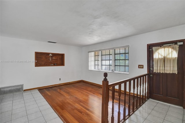 entrance foyer featuring plenty of natural light and light hardwood / wood-style flooring