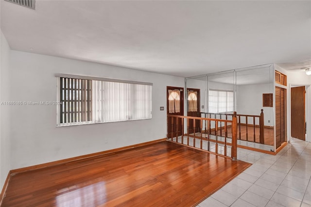 empty room with light hardwood / wood-style flooring