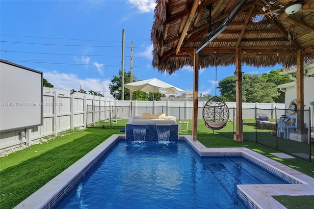 view of pool featuring pool water feature, a gazebo, an outdoor hangout area, and a lawn